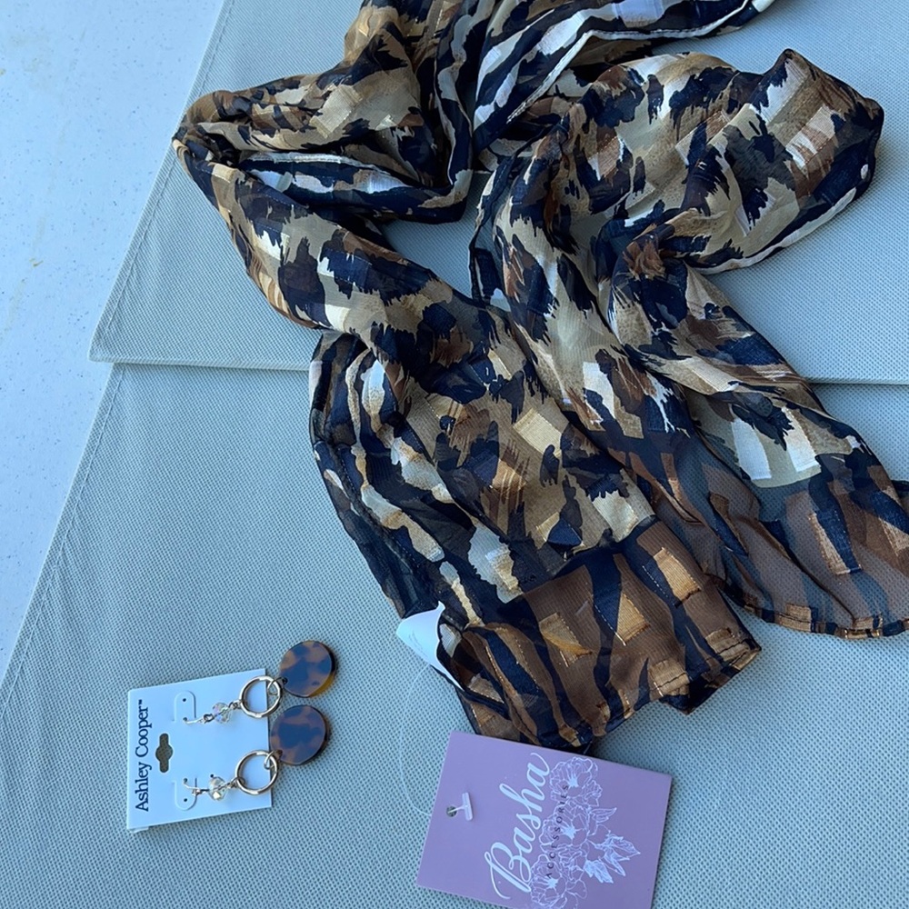 Leopard print scarf.58 in length 12 in wide matching pierced earrings.